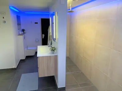a bathroom with a sink and a toilet in a room at LK1924-Lokken-Lydiavej-4 in Løkken