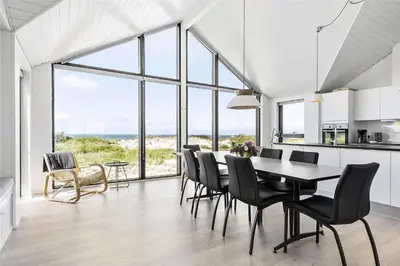 a kitchen and dining room with a table and chairs at LK1240-Lokken-Rosavej-13 in Løkken
