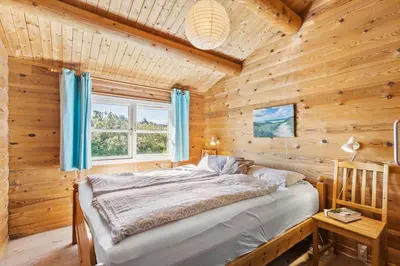 a bedroom with a bed in a wooden room at LK1427-Lokken-Nannasvej-26 in Løkken