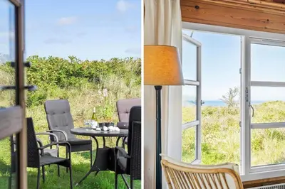 a patio with a table and chairs and a view of the ocean at LK1427-Lokken-Nannasvej-26 in Løkken