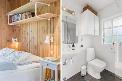 a bedroom with a bed and a bathroom with a sink at LK2098-Lokken-Magdalenevej-51 in Løkken
