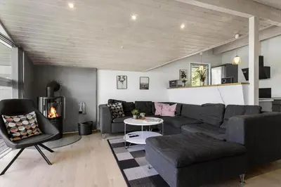 a living room with a couch and a fireplace at LK1892-Lokken-Marthinesvej-37 in Løkken