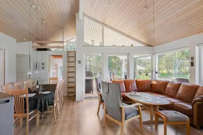 a living room with a couch and a table and chairs at LK781-Lokken-Margrethevej-6 in Løkken