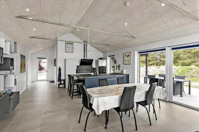 a kitchen and dining room with a table and chairs at LK1824-Lokken-Marthasvej-16 in Løkken
