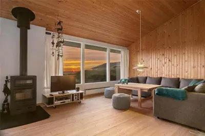 a living room with a couch and a fireplace at LK1054-Lokken-Lottesvej-22 in Løkken