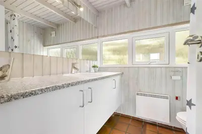 a bathroom with a sink and a toilet at LK552-Lokken-Ornegaardsvej-14 in Løkken