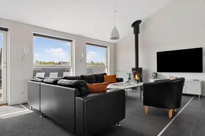 a living room with a couch and a tv at LK1979-Lokken-Kringelbaekvej-42 in Løkken