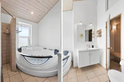 a white bathroom with a tub and a sink at LK2095-Lokken-Mievej-28 in Løkken