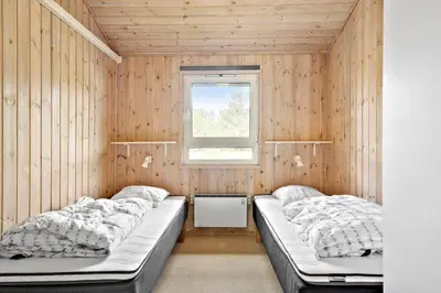 a bedroom with two beds and a window at LK350-Lokken-Piasvej-11 in Løkken