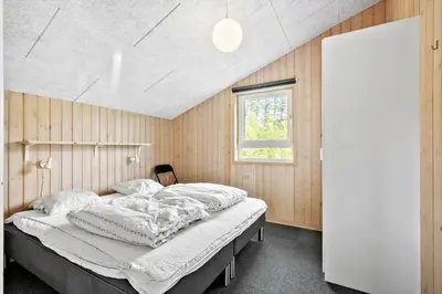 a bedroom with a bed and a window at LK350-Lokken-Piasvej-11 in Løkken