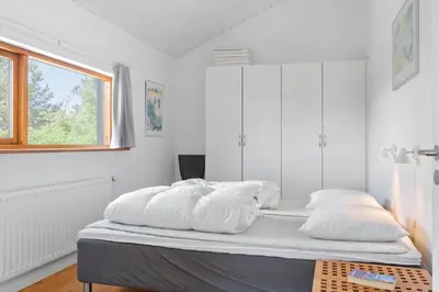a white room with a bed with white pillows at LK1948-Lokken-Karinavej-48 in Løkken