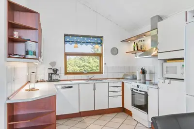 a kitchen with white appliances and a window at LK1948-Lokken-Karinavej-48 in Løkken