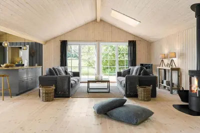a living room with two couches and a fireplace at LK1394-Lokken-Lisevej-5 in Løkken