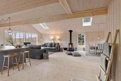 a living room with a couch and a fireplace at LK1394-Lokken-Lisevej-5 in Løkken
