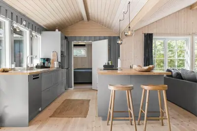 a kitchen with a counter and two bar stools at LK1394-Lokken-Lisevej-5 in Løkken