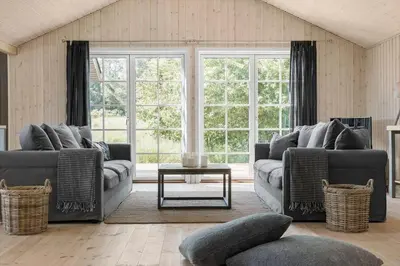 a living room with two couches and a table at LK1394-Lokken-Lisevej-5 in Løkken