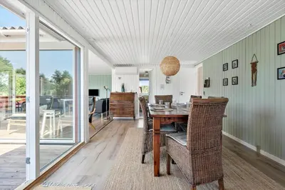 a dining room with a table and chairs at LK1935-Lokken-Pernillevej-17 in Løkken