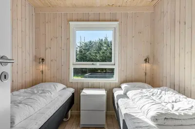 two beds in a room with a window at LK780-Lokken-Margrethevej-4 in Løkken