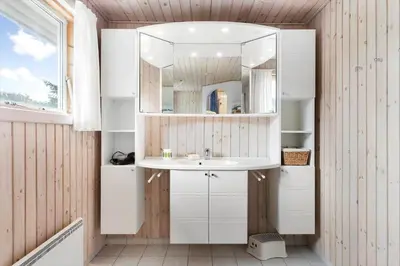 a bathroom with a sink and a mirror at LK2071-Lokken-Marensvej-3 in Løkken