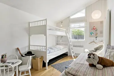 a childs bedroom with a bunk bed and a dog laying on a bed at LK1790-Lokken-Gronhoj-Strandvej-174 in Løkken