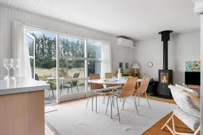 a kitchen and dining room with a table and chairs at LK2115-Lokken-Marthasvej-7 in Løkken