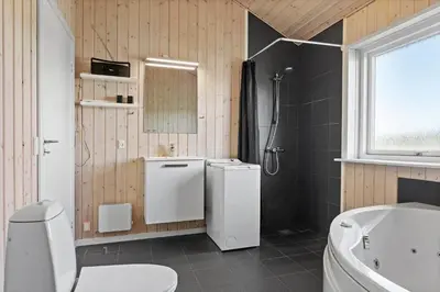 a bathroom with a toilet and a sink and a tub at LK167-Lokken-Kringelbaekvej-43 in Løkken