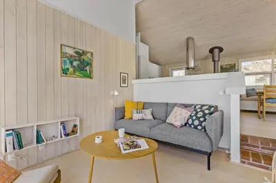 a living room with a couch and a table at LK1985-Lokken-Monasvej-24 in Løkken