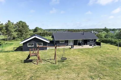 a house with a playground in front of it at LK902-Lokken-Mievej-42 in Løkken