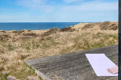a piece of paper sitting on a table near the ocean at LK1463-Lokken-Rosavej-11 in Løkken