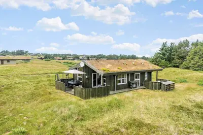 a small house in a field with a roof at LK248-Lokken-Sinnesvej-43 in Løkken