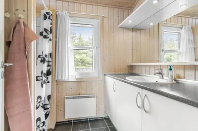 a bathroom with a sink and a shower at LK248-Lokken-Sinnesvej-43 in Løkken