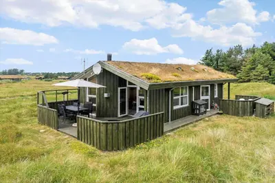 a green house with a grass roof on a field at LK248-Lokken-Sinnesvej-43 in Løkken