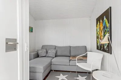 a living room with a gray couch and a table at LK329-Lokken-Marensvej-12 in Løkken