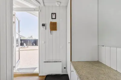 a room with a door leading to a garage at LK329-Lokken-Marensvej-12 in Løkken