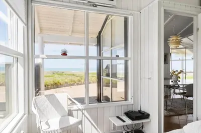 a room with a window with a view of the beach at LK329-Lokken-Marensvej-12 in Løkken
