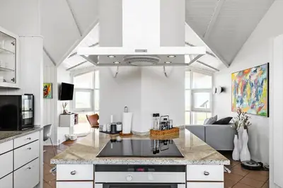 a kitchen with a stove top oven in a room at LK329-Lokken-Marensvej-12 in Løkken