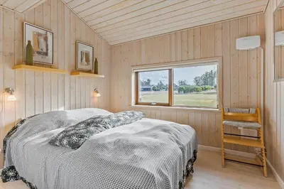 a bedroom with a bed in a room with a window at LK537-Lokken-Mievej-20 in Løkken