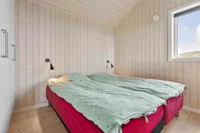 a bedroom with a bed in a room with a window at LK1280-Lokken-Kettrup-Bjerge-Vej-98 in Løkken