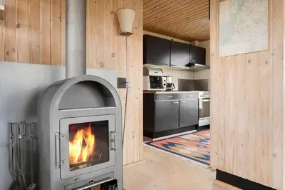 a kitchen with a fireplace in a room at LK784-Lokken-Sinnesvej-7 in Løkken