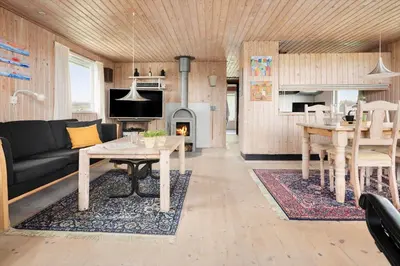 a living room with a couch and a table at LK784-Lokken-Sinnesvej-7 in Løkken