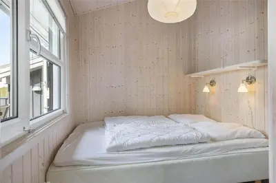 a white bed in a room with a window at LK1179-Lokken-Normasvej-6 in Løkken