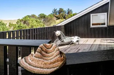 a large crochet bag sitting on a table on a deck at LK2065-Lokken-Rikkesvej-5 in Løkken