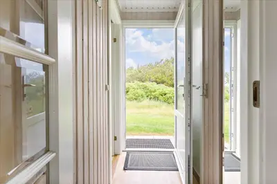 a hallway with a door leading into a house at LK1779-Lokken-Lydiavej-2 in Løkken