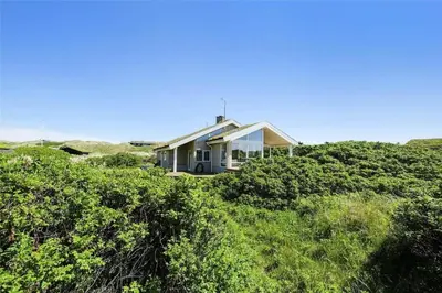 a house on top of a hill with bushes at LK1716-Lokken-Marthasvej-28 in Løkken