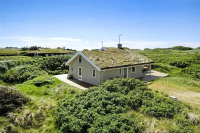 a house with a grass roof on top of a field at LK1716-Lokken-Marthasvej-28 in Løkken