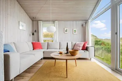 a living room with a couch and a table at LK2033-Lokken-Madsinesvej-13 in Løkken