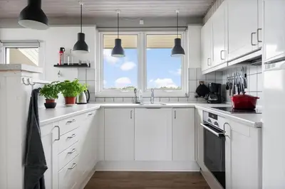 a white kitchen with a sink and a window at LK2033-Lokken-Madsinesvej-13 in Løkken
