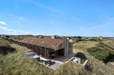 a house on the beach with a rusty roof at LK1272-Lokken-Ruthsvej-17 in Løkken