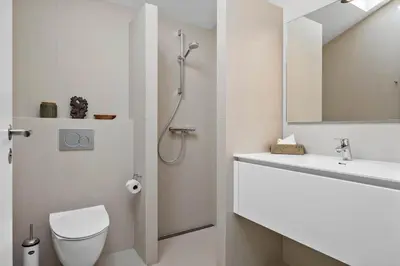 a bathroom with a shower and a toilet and a sink at LK1272-Lokken-Ruthsvej-17 in Løkken