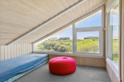 a room with a bed and a large window at LK431-Lokken-Kettrup-Bjerge-Vej-62 in Løkken